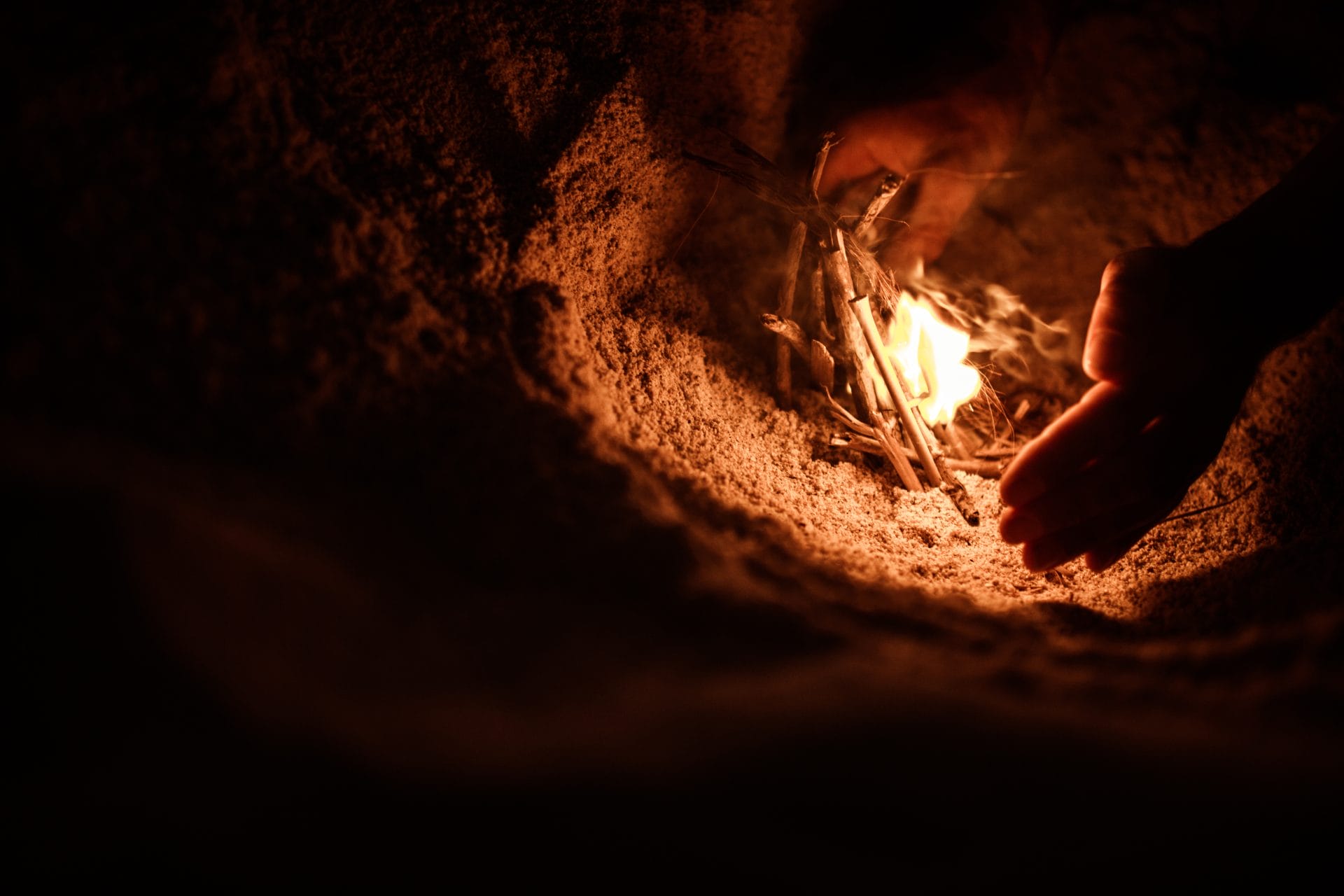 tourist fires up a bonfire on the beach on the island of Sumbawa